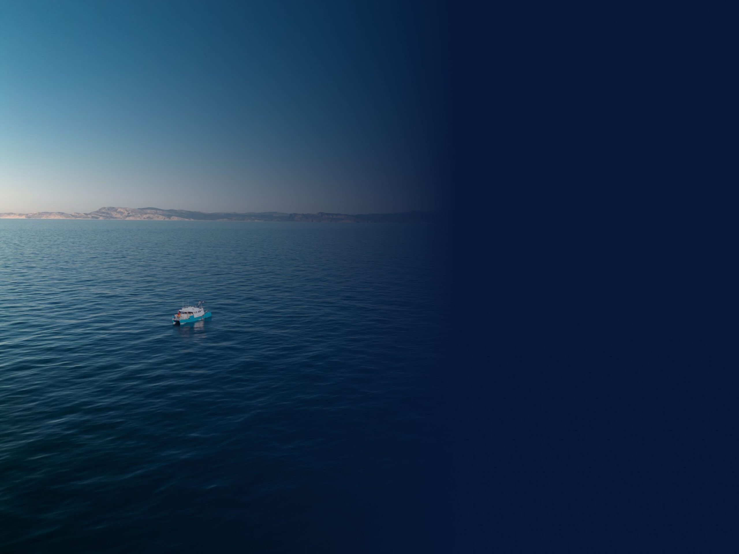 picture of ocean with small boat 